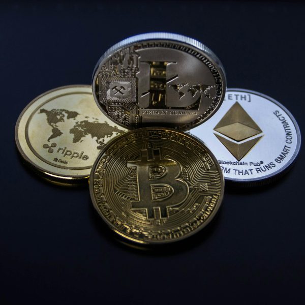 Detailed photo showcasing bitcoin, ethereum, litecoin, and ripple coins representing digital currency.