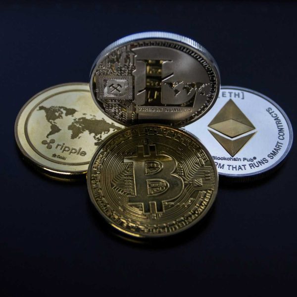 Detailed photo showcasing bitcoin, ethereum, litecoin, and ripple coins representing digital currency.